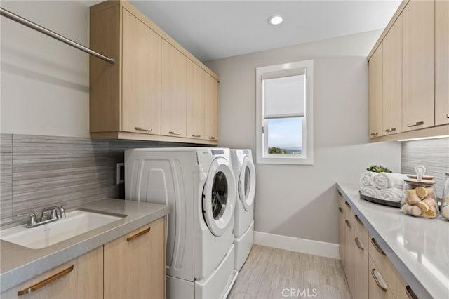 9522 N Andora Ave, Chatsworth, CA 91311 - washroom featuring baseboards, recessed lighting, washing machine and dryer, cabinet space, and a sink