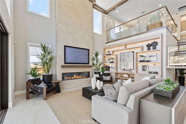 9522 N Andora Ave, Chatsworth, CA 91311 - living room featuring baseboards, a tile fireplace, a towering ceiling, and plenty of natural light
