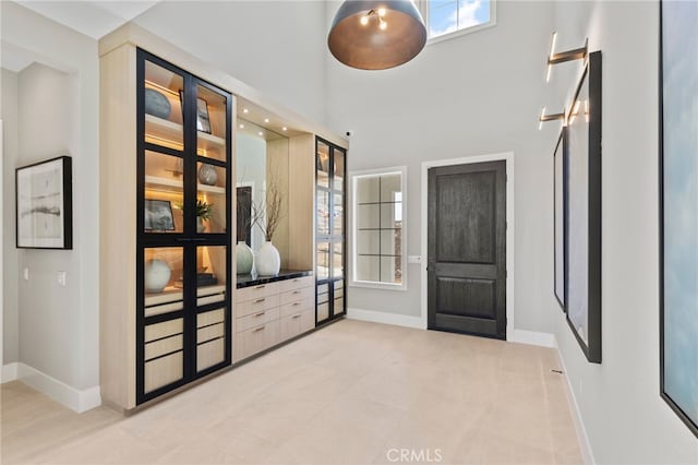 9522 N Andora Ave, Chatsworth, CA 91311 - mudroom featuring a high ceiling, light tile patterned flooring, and baseboards