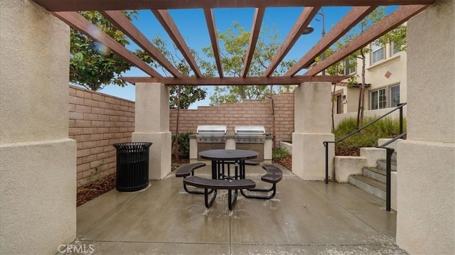 view of patio with grilling area, a pergola, and fence