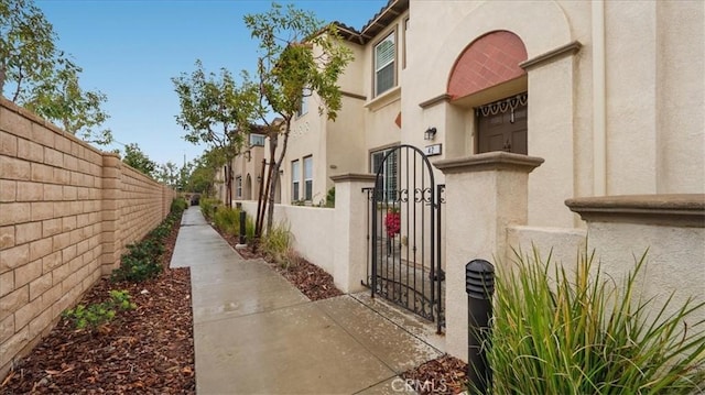 exterior space with a fenced front yard and a residential view