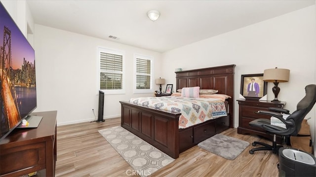 bedroom with visible vents, baseboards, and light wood-style floors