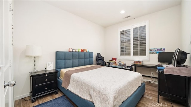 bedroom with visible vents, recessed lighting, baseboards, and wood finished floors