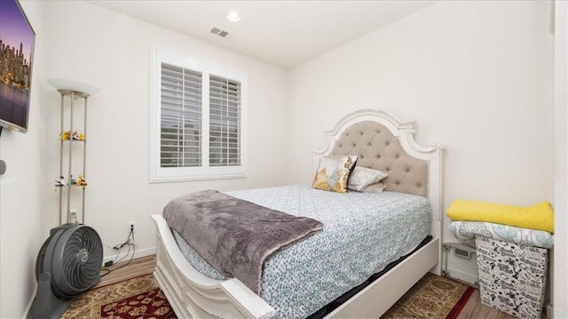 bedroom featuring recessed lighting, wood finished floors, visible vents, and baseboards