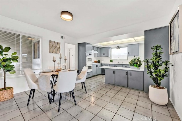 dining area featuring light tile patterned floors and visible vents