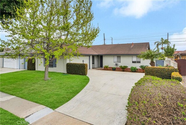 ranch-style house featuring stucco siding, driveway, fence, a front yard, and a garage