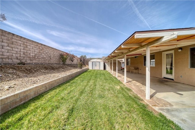 view of yard featuring a fenced backyard, a patio, a storage shed, and an outdoor structure