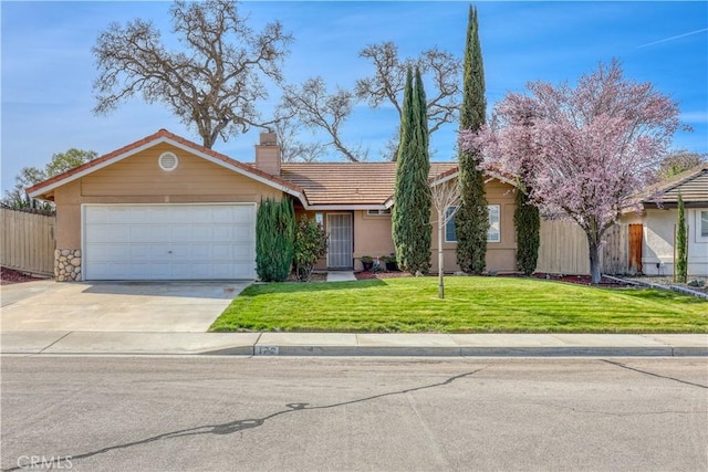 view of front of house with stucco siding, driveway, a front lawn, a garage, and a chimney