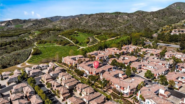 view of property location featuring a mountain backdrop and nearby suburban area
