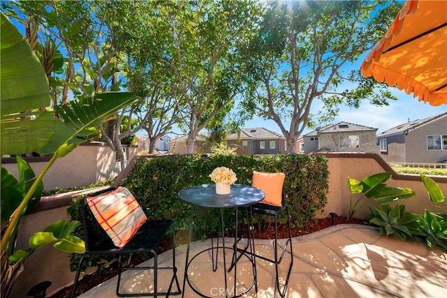 view of patio / terrace featuring fence and a residential view
