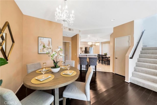 dining room with dark wood-type flooring, stairway, a chandelier, baseboards, and recessed lighting