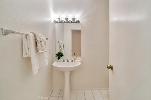 bathroom featuring tile patterned flooring and baseboards