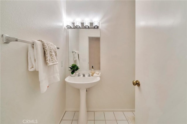 bathroom featuring tile patterned flooring and baseboards