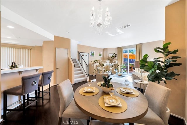 dining space with visible vents, dark wood finished floors, recessed lighting, stairs, and a notable chandelier