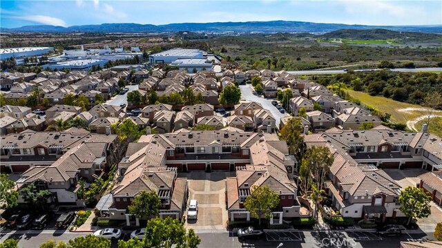 drone / aerial view featuring a residential view and a mountain view