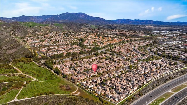 birds eye view of property featuring a mountain view and a residential view