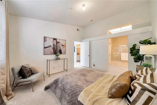 bedroom with carpet, a towering ceiling, and a skylight