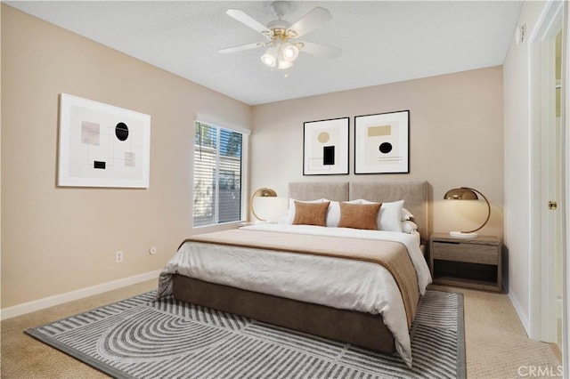 bedroom with ceiling fan, baseboards, and carpet