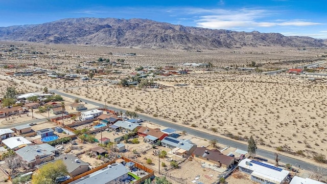 birds eye view of property with view of desert and a mountain view