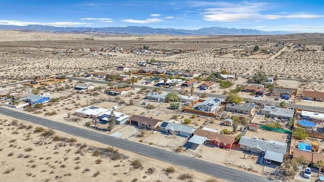 bird's eye view with a mountain view and view of desert