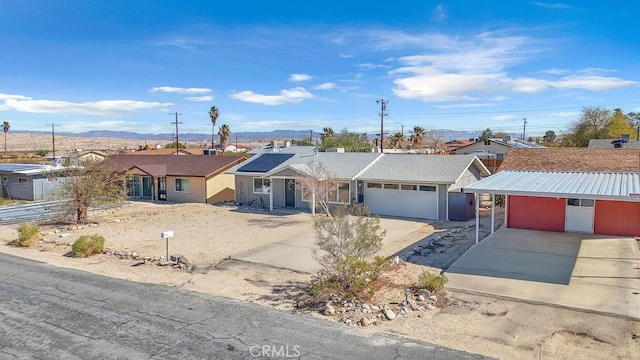 ranch-style home with a residential view, concrete driveway, an attached garage, and fence