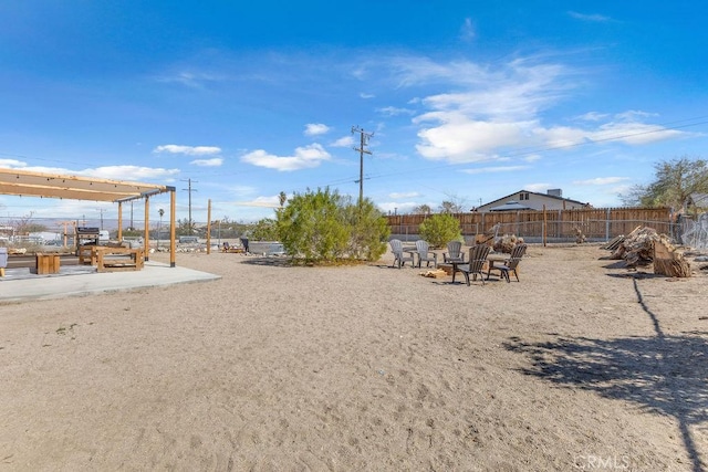 view of yard with a fire pit and fence