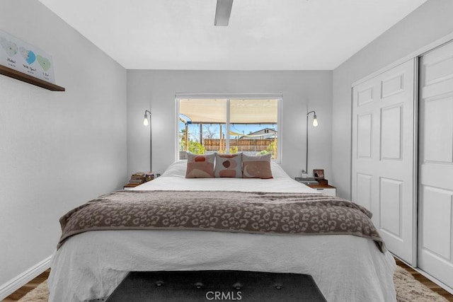 bedroom with baseboards, wood finished floors, and a ceiling fan