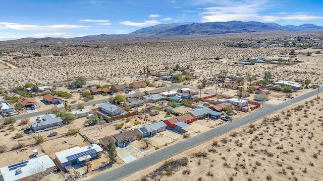 drone / aerial view featuring a mountain view and a desert view