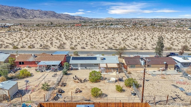 drone / aerial view featuring view of desert and a mountain view