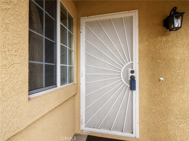 property entrance with stucco siding