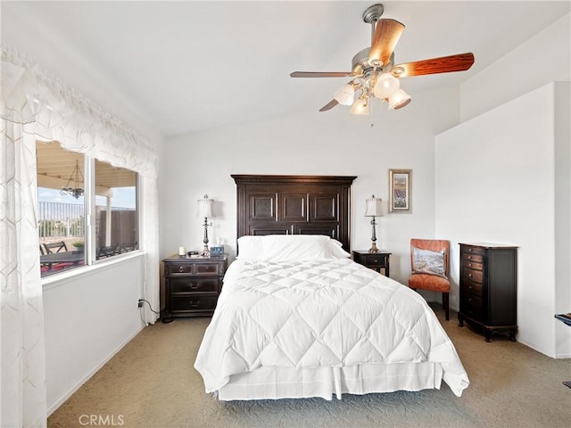 bedroom with lofted ceiling, light colored carpet, and a ceiling fan