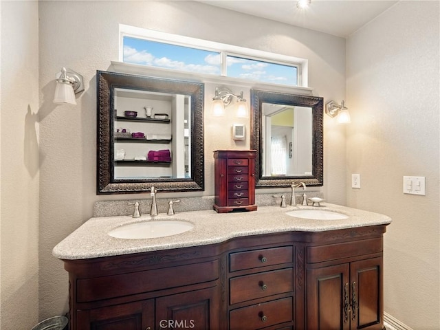 bathroom with a sink and double vanity