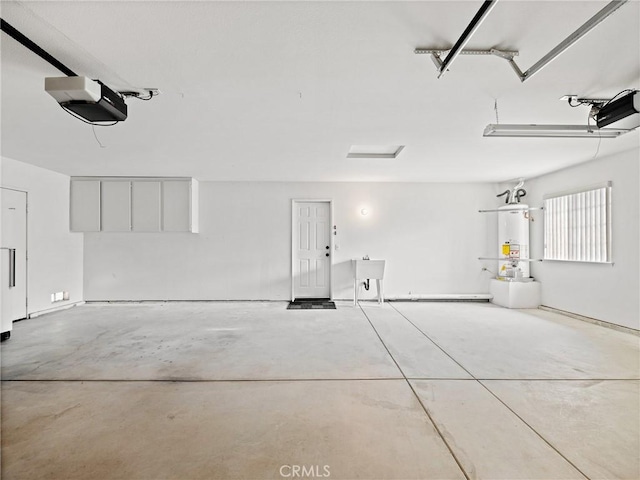 garage featuring water heater and a garage door opener