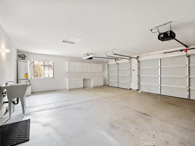 garage with strapped water heater and a garage door opener