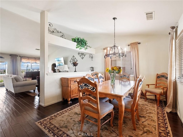 dining room featuring visible vents, baseboards, an inviting chandelier, and dark wood-style floors