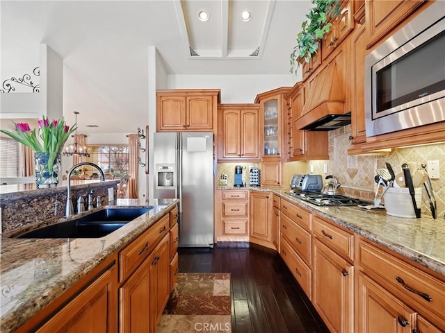 kitchen featuring a sink, stainless steel appliances, decorative backsplash, light stone countertops, and dark wood-style flooring