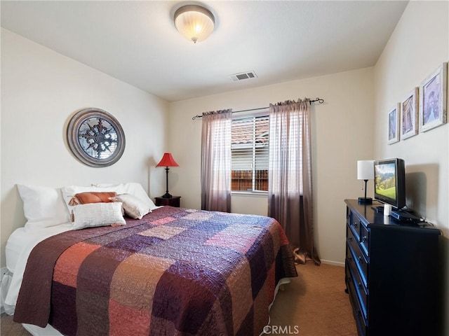 bedroom with baseboards, visible vents, and light carpet