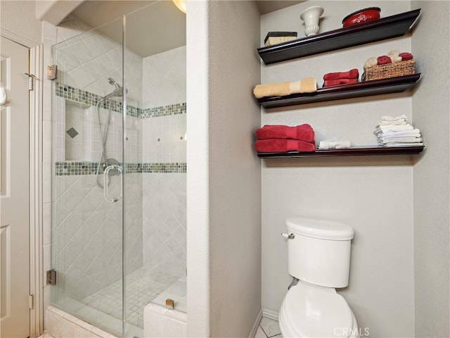 bathroom featuring a shower stall and toilet