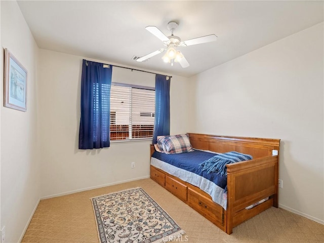 carpeted bedroom with a ceiling fan and baseboards