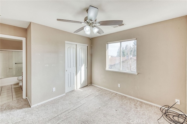 unfurnished bedroom featuring a closet, baseboards, visible vents, and carpet flooring