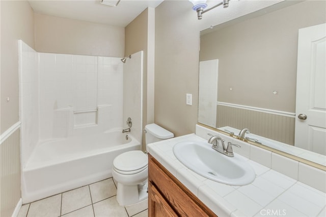 full bathroom featuring a wainscoted wall, toilet, shower / bathing tub combination, tile patterned floors, and vanity