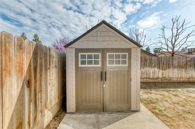 view of shed with a fenced backyard