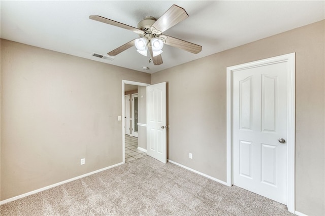 unfurnished bedroom with visible vents, ceiling fan, baseboards, and carpet