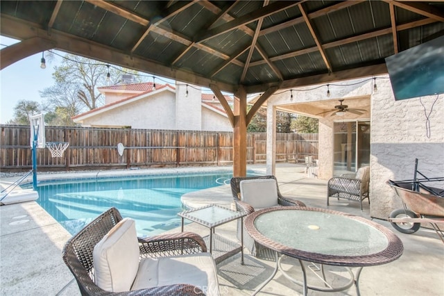 view of swimming pool featuring a fenced backyard, a fenced in pool, a gazebo, and a patio