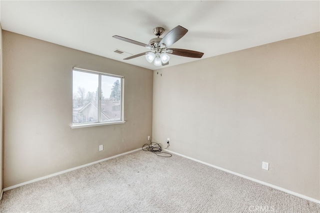 spare room featuring a ceiling fan, carpet flooring, baseboards, and visible vents