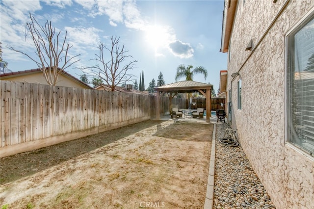 view of yard featuring a gazebo, a fenced backyard, and a patio