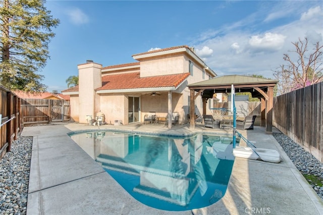 view of swimming pool with a gazebo, a patio, a fenced backyard, and a ceiling fan