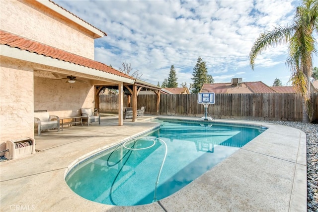 view of pool with a patio area, a fenced in pool, a ceiling fan, and a fenced backyard