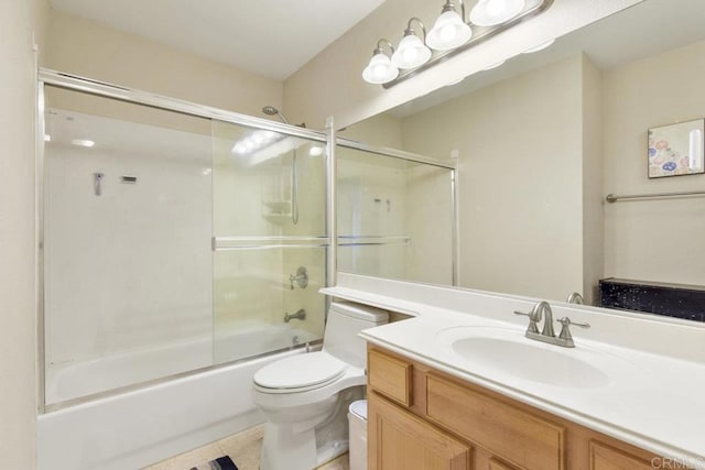 full bathroom with tile patterned floors, toilet, vanity, and shower / bath combination with glass door