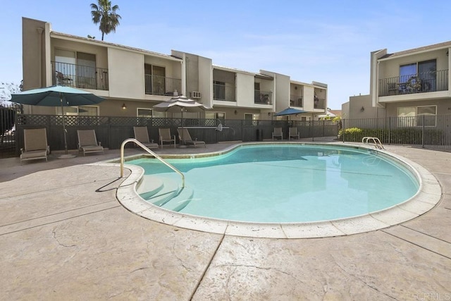 pool featuring a patio and fence